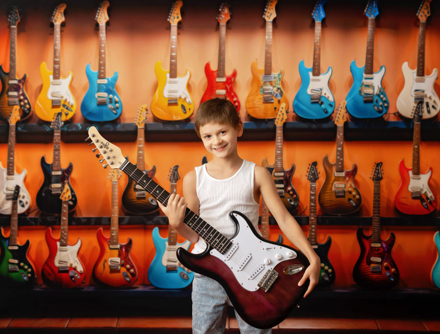 Newnan children's photographer, boy with electric guitar in studio