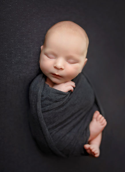 Newnan newborn photographer, baby boy in grey swaddle