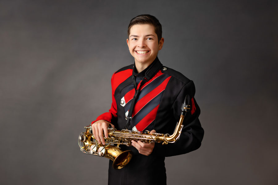 senior portrait photographer near Douglasville, teen in band uniform with saxophone