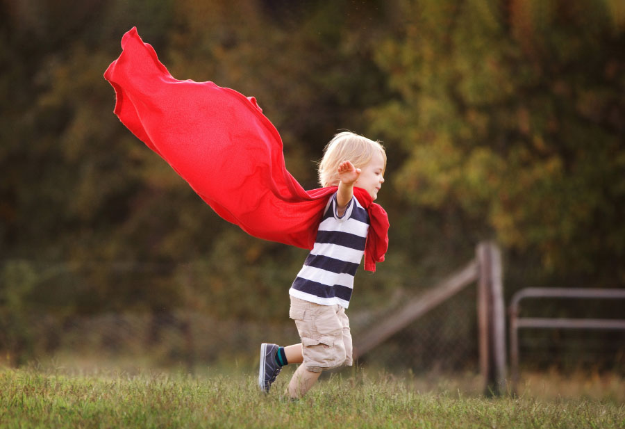 Villa Rica kids' photographer, boy outside playing in red cape