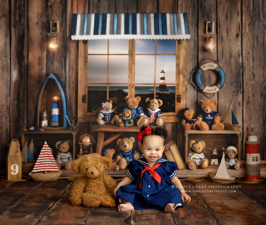 Atlanta baby photographer, girl sitting by teddy bear on nautical studio set
