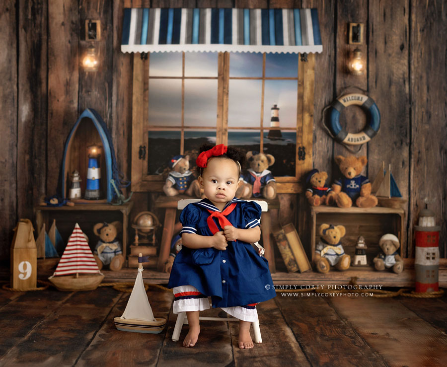 Carrollton baby photographer in GA, girl with boat and nautical bear studio theme
