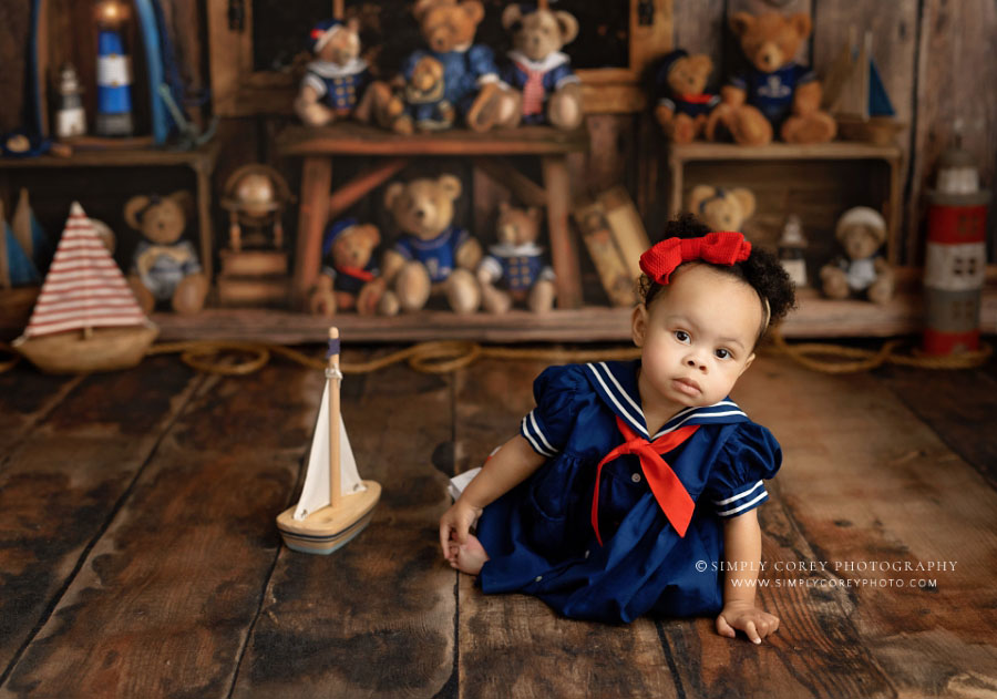 Newnan baby photographer, girl with boat on nautical bear studio set