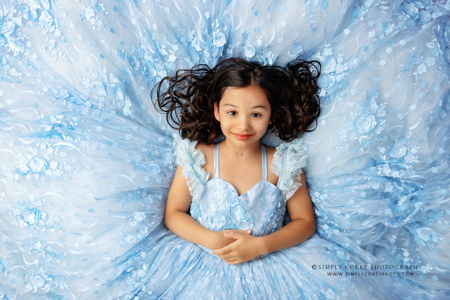 Atlanta dream dress photographer, girl lying down on blue princess dress