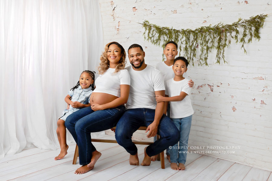 Atlanta family photographer, studio maternity session with white brick and curtains