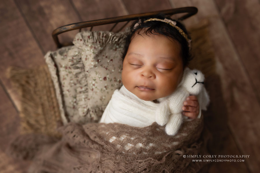 newborn photographer near Douglasville, sleeping baby girl on a bed with a bunny