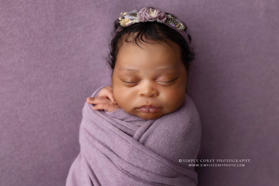 Newnan newborn photographer, baby girl swaddled on purple backdrop